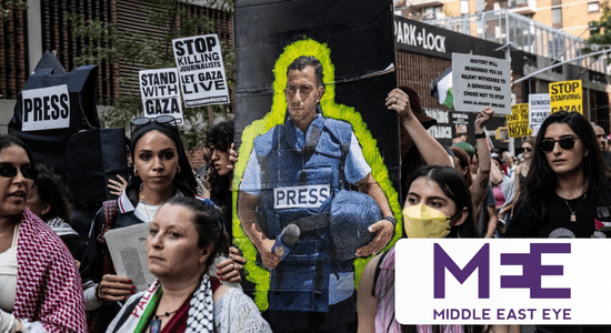 A crowd of protesters hold up signs that read "Stand with Gaza," "Stop Killing Journalists" and "Let Gaza Live." One protester holds up a large sign with a painting of Anas Al-Sharif, wearing a blue PRESS protective vest and holding a blue helmet and motorcycle. At bottom right, the logo for Middle East Eye. 